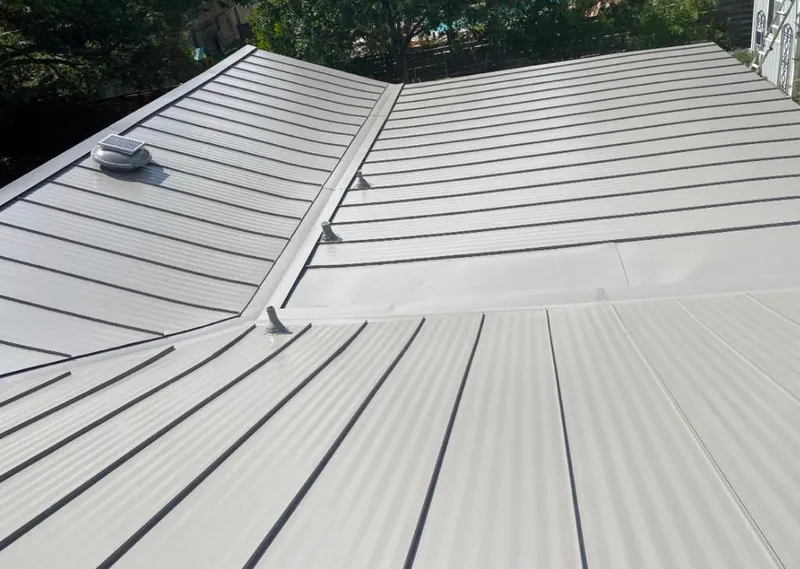 Solar attic fan installed on a metal roof for Roof Ventilation in Zimmerman
